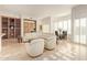 Open living room with white leather sectional sofa and built-in shelving at 11003 E Turnberry Rd, Scottsdale, AZ 85255