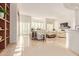 Bright and airy living room with large windows, light tile floors, and white leather furniture at 11003 E Turnberry Rd, Scottsdale, AZ 85255