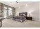 Spacious bedroom with plush carpeting, gray upholstered bed, and large windows at 11509 E Beck Ln, Scottsdale, AZ 85255