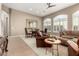 Spacious living room with leather furniture, fireplace, and large windows at 11509 E Beck Ln, Scottsdale, AZ 85255