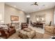 Comfortable living room with leather seating, ottoman and a large stone fireplace at 11509 E Beck Ln, Scottsdale, AZ 85255