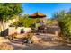 Covered patio with seating area and umbrella, great for outdoor dining at 11509 E Beck Ln, Scottsdale, AZ 85255