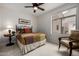 Cozy bedroom with a ceiling fan and adjacent seating at 11516 E Buckskin Trl, Scottsdale, AZ 85255