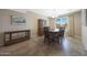 Traditional dining room with a wooden table, chairs, china cabinet, and a window with natural light at 13530 W Spanish Garden Dr, Sun City West, AZ 85375