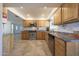 Bright kitchen featuring stainless steel appliances, tiled backsplash, wooden cabinets, and granite countertops at 13530 W Spanish Garden Dr, Sun City West, AZ 85375