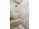 Walk-in shower with pebble floor and built-in seat at 13816 N 109Th Ave, Sun City, AZ 85351