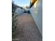 Gravel backyard with desert landscaping and AC unit at 14371 W Morning Star Trl, Surprise, AZ 85374
