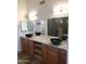 Double vanity bathroom with granite countertops and large mirrors at 14371 W Morning Star Trl, Surprise, AZ 85374