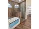 Spa-like bathroom with a soaking tub, walk-in shower, and wood-like tile at 14371 W Morning Star Trl, Surprise, AZ 85374