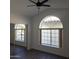 Spacious bedroom with large arched window and mirrored closet at 14371 W Morning Star Trl, Surprise, AZ 85374