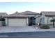 Single-story home with tile roof, two-car garage, and well-manicured landscaping at 14371 W Morning Star Trl, Surprise, AZ 85374