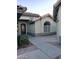 Side view of house with walkway, landscaping, and arched window at 14371 W Morning Star Trl, Surprise, AZ 85374