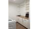 Laundry room with washer, dryer, cabinets and shelving at 14371 W Morning Star Trl, Surprise, AZ 85374