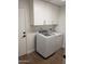 Bright laundry room with washer, dryer, and ample storage at 14371 W Morning Star Trl, Surprise, AZ 85374