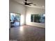 Living area with hardwood floors, sliding doors, and a ceiling fan at 14371 W Morning Star Trl, Surprise, AZ 85374