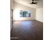 Spacious living room with hardwood floors and large windows at 14371 W Morning Star Trl, Surprise, AZ 85374
