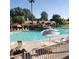 Relaxing community pool with lounge chairs and patio tables at 14371 W Morning Star Trl, Surprise, AZ 85374