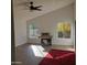 Bright sunroom features a ceiling fan, wood-look floors, and access to the backyard at 14371 W Morning Star Trl, Surprise, AZ 85374
