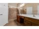 Main bathroom with double vanity, walk-in shower, and tile at 15491 W Amelia Dr, Goodyear, AZ 85395