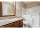 Bathroom with walk-in tub, single vanity, and toilet at 15491 W Amelia Dr, Goodyear, AZ 85395