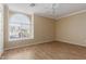 Bedroom with arched window, tile floors, and ceiling fan at 15491 W Amelia Dr, Goodyear, AZ 85395