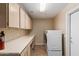 Laundry room with washer, dryer, and cabinets at 15491 W Amelia Dr, Goodyear, AZ 85395