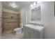 Updated bathroom with walk-in shower and gray vanity at 16796 W Pierce St, Goodyear, AZ 85338