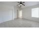 Bedroom with tile flooring, ceiling fan, and double door closet at 16796 W Pierce St, Goodyear, AZ 85338