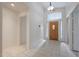 Bright entryway with tiled floors and a wooden front door at 16796 W Pierce St, Goodyear, AZ 85338