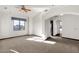 Large bedroom with carpeted floor, window, and access to hallway at 1777 W Ocotillo Rd # 23, Chandler, AZ 85248