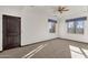 Bright bedroom with carpeted floors, ceiling fan, and large windows at 1777 W Ocotillo Rd # 23, Chandler, AZ 85248