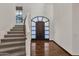 Two-story entry with curved staircase, hardwood floors, and arched entry door at 1777 W Ocotillo Rd # 23, Chandler, AZ 85248