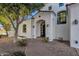 Front entrance with arched entryway, stone walkway, and mature trees at 1777 W Ocotillo Rd # 23, Chandler, AZ 85248