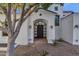 Front entrance with arched entryway, stone walkway, and mature trees at 1777 W Ocotillo Rd # 23, Chandler, AZ 85248
