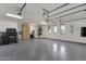 Large garage with epoxy flooring, storage cabinets, and windows at 1777 W Ocotillo Rd # 23, Chandler, AZ 85248