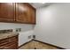 Laundry room with wood cabinets and granite countertop at 1777 W Ocotillo Rd # 23, Chandler, AZ 85248