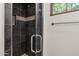 Modern shower with dark tile and glass enclosure at 1777 W Ocotillo Rd # 23, Chandler, AZ 85248