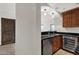 Wet bar with dark countertops, wood cabinets, and wine cooler at 1777 W Ocotillo Rd # 23, Chandler, AZ 85248