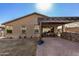 Backyard view of home with covered patio, dining area, and bar at 18188 W Fulton St, Goodyear, AZ 85338