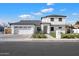 Stunning two-story home with a modern farmhouse design, featuring a three-car garage and a beautifully landscaped front yard at 1822 N Oracle Cir, Mesa, AZ 85203