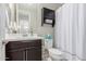 Clean bathroom featuring a sink, toilet, and shower with a shower curtain at 1921 E Lantana Dr, Chandler, AZ 85286