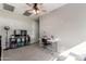 Bedroom with a ceiling fan, a white desk with chair, and a wall-mounted television set at 1921 E Lantana Dr, Chandler, AZ 85286