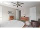 Bedroom featuring a ceiling fan, dresser storage, chair seating, and closet entrances at 1921 E Lantana Dr, Chandler, AZ 85286