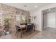 Elegant dining room featuring a stone accent wall, modern lighting, and stylish decor at 1921 E Lantana Dr, Chandler, AZ 85286
