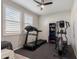 Bright exercise room with a ceiling fan, natural light, treadmill, and elliptical machine at 1921 E Lantana Dr, Chandler, AZ 85286