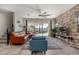 Bright living room with modern decor, stone accent wall, and access to the backyard at 1921 E Lantana Dr, Chandler, AZ 85286