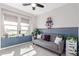 Inviting living room featuring a stylish gray sofa and natural light from the large windows at 1921 E Lantana Dr, Chandler, AZ 85286