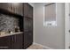 Mudroom showcases built-in cabinets with granite countertop and modern mosaic backsplash at 1921 E Lantana Dr, Chandler, AZ 85286