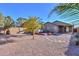 Large backyard with gravel, mature trees, and a hot tub at 19572 N Sandalwood Dr, Maricopa, AZ 85138