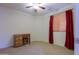 Bedroom with wood desk and chair, and red curtains at 19572 N Sandalwood Dr, Maricopa, AZ 85138